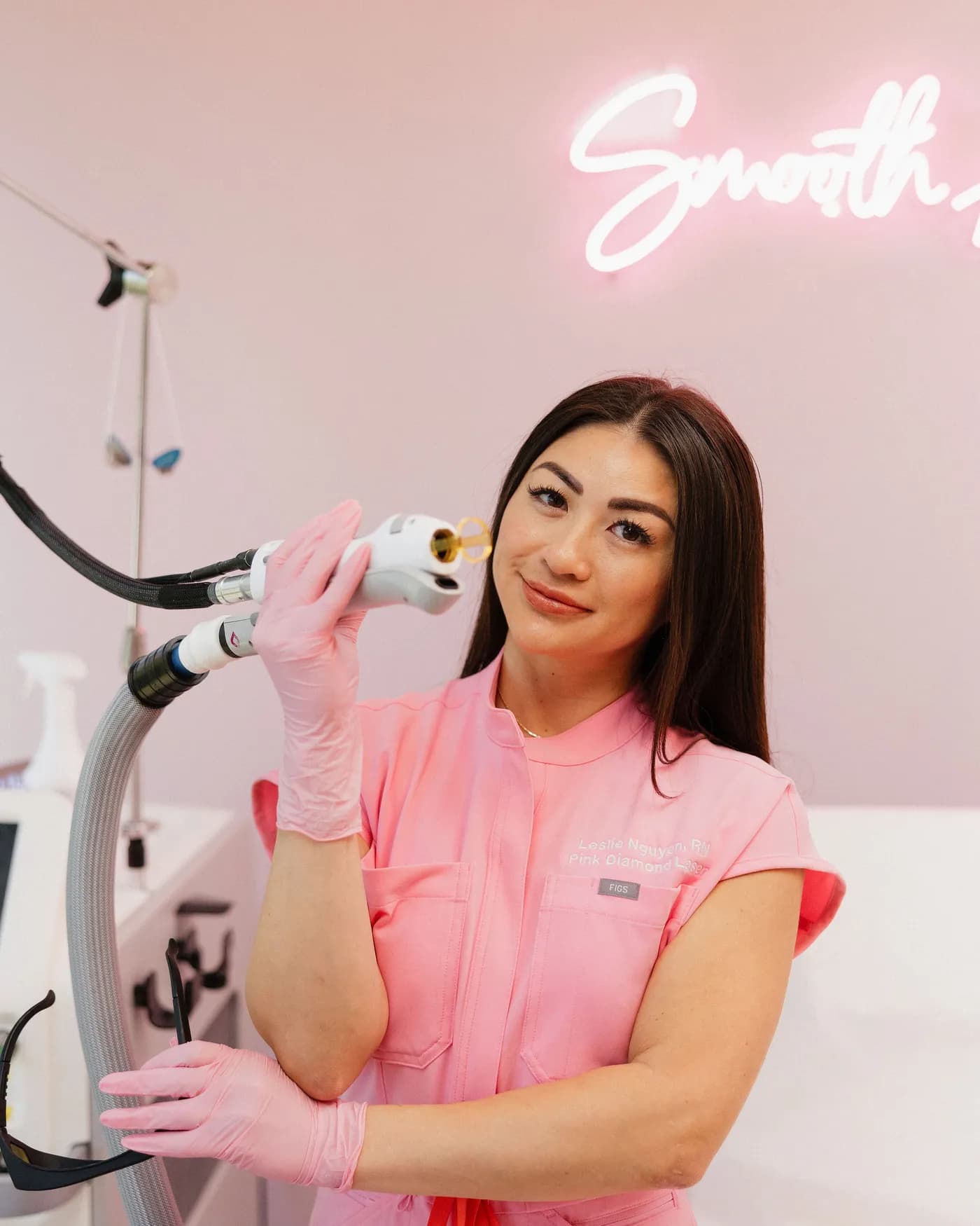 Leslie Nguyen, RN, founder of Pink Diamond Laser, holding the Candela GentleMax Pro handpiece in her treatment room